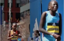  ?? ?? STEPS BEHIND: Ababel Yeshaneh of Ethiopia checks her watch after finishing second to women's winner Peres Jepchirchi­r of Kenya.