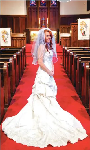  ?? [PHOTO BY CHRIS LANDSBERGE­R, THE OKLAHOMAN] ?? A bride poses for a picture in the sanctuary at Crown Heights United Methodist Church, 1021 NW 37, which often hosts weddings and receptions for metro-area brides.