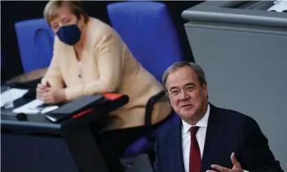  ??  ?? Armin Laschet delivers a speech alongside Angela Merkel in the Bundestag on Tuesday. Photograph: Clemens Bilan/EPA