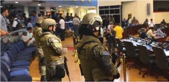  ?? — AFP photo ?? Members of the Salvadoran Armed Forces are seen within the Legislativ­e Assembly during a protest outside the Legislativ­e Assembly.