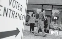  ?? JONATHON GRUENKE/STAFF FILE ?? Voters and election officials enter the registrar’s office in Washington Square Shopping Center in York County during Super Tuesday on March 3.