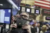  ?? RICHARD DREW — THE ASSOCIATED PRESS ?? Trader Eric Schumacher works on the floor of the New York Stock Exchange Thursday. U.S. stocks took their biggest loss in three weeks after a late sell-off. Apple, which is mired in a slump, fell to its lowest price in about two months and dragged the...