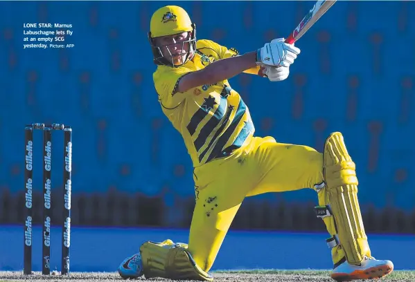  ?? Picture: AFP ?? LONE STAR: Marnus Labuschagn­e lets fly at an empty SCG yesterday.