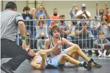  ?? STAFF PHOTO BY MATT HAMILTON ?? The crowd cheers after Signal Mountain’s Ethan Uhorchuk, right, pinned Gibbs’ Porter Finstad in the 106-pound final during the TSSAA Class A/ AA state traditiona­l tournament on Feb. 24 at the Chattanoog­a Convention Center.