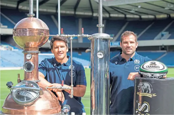  ??  ?? Thirsty work for Sam Johnson and Fraser Brown promoting Scotland Rugby’s renewed sponsorshi­p deal with Crabbie’s.