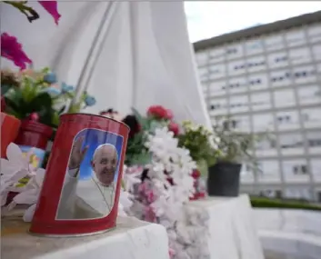  ?? Andrew Medichini/Associated Press ?? A candle with the image of Pope Francis is left in front of the windows of the Agostino Gemelli University Polyclinic in Rome, Sunday, where Pope Francis is recovering from the abdominal surgery he underwent on Wednesday.