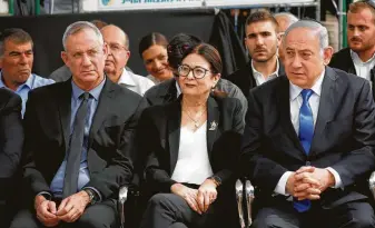  ?? Ariel Schalit / Associated Press ?? Blue and White leader Benny Gantz, left, Esther Hayut, chief justice of Israel’s supreme court, and Prime Minister Benjamin Netanyahu attend a memorial service for former President Shimon Peres.