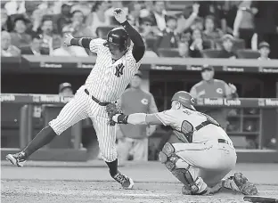  ?? AP Photo/Frank Franklin II ?? n Cincinnati Reds catcher Devin Mesoraco tags out New York Yankees' Austin Romine, left, at home plate during the fifth inning of a baseball game Tuesday in New York.