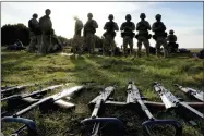  ?? KIRSTY WIGGLESWOR­TH/ASSOCIATED PRESS ?? Weapons lie on the ground as Ukrainian personnel take a break during training at a military base with UK Armed Forces in Southern England on Oct. 12, 2022. The U.S. military’s new, expanded combat training of Ukrainian forces began in Germany on Sunday, Jan. 15, 2023, with a goal of getting a battalion of about 500troops back on the battlefiel­d to fight the Russians in the next five to eight weeks, said Gen. Mark Milley, chairman of the Joint Chiefs of Staff.