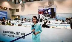  ??  ?? Systems check: A Chinese journalist speaking at the media centre for the summit in Xiamen. — AFP