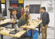  ??  ?? Students build a trebuchet in a robotics class at The Gunnery.