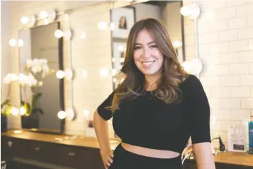  ?? MARK LENNIHAN/THE ASSOCIATED PRESS ?? Hair salon owner Erika Wasser stands in her Glam+Go studio in New York. Wasser owns nine salons in three cities.