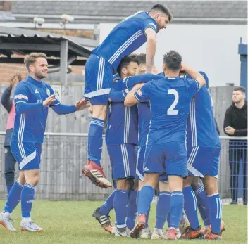  ??  ?? Peterborou­gh Sports celebrate a goal against Sutton Coldfield.