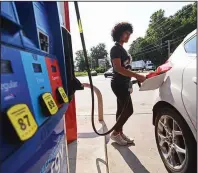  ?? (Arkansas Democrat-Gazette/Staci Vandagriff) ?? Zoe Keith of Little Rock fills up her car Wednesday morning at the DoubleBee’s Exxon gas station on Cantrell Road in Little Rock. Many people will be taking to the road for the Labor Day holiday this weekend.