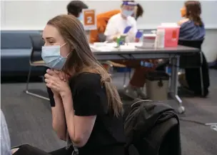  ?? Associated Press ?? ■ Dr. Margaret Coates reacts after receiving the Pfizer-BioNTech COVID-19 vaccine at the University of Texas Health Austin Dell Medical School on Tuesday in Austin.