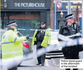  ??  ?? Police stand guard in the aftermath of the incident