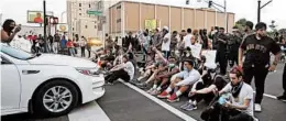  ?? DARRON CUMMINGS/AP ?? Protesters in Louisville, Kentucky, sit at an intersecti­on during a protest Saturday over the deaths of Breonna Taylor and George Floyd. Taylor was fatally shot in a March raid.