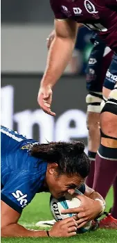  ?? PHOTOSPORT ?? Blues wing Caleb Clarke scores during last night’s Super Rugby Pacific match against the Reds at Eden Park in Auckland. He was in fine form, also delivering several blockbusti­ng runs.