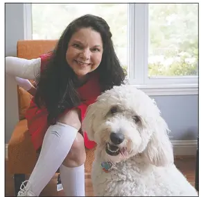  ?? (Hot Springs Sentinel-Record) ?? Marine Corps veteran Deanna Gehman poses with her service dog Cleopatra in her home on Friday in Hot Springs.