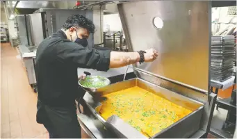  ?? TONY CALDWELL ?? Coconut Lagoon's award-winning chef, Joe Thottungal, cooks in the Fairmont Château Laurier kitchen in partnershi­p with Food for Thought, an organizati­on providing people with quality, nutritious meals.