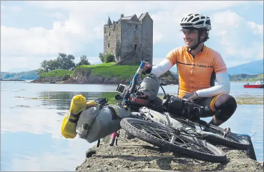  ??  ?? HOME GROUND: Markus Stitz enjoys a well-earned rest from his efforts against the scenic backdrop of Castle Stalker near Oban, Scotland.
