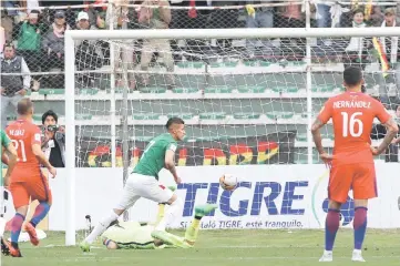  ??  ?? Bolivia’s Juan Carlos Arce (centre) scores a goal against Chile during their 2018 World Cup qualifier football match in La Paz. — Reuters photo