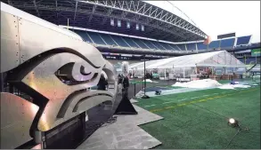  ?? Ted S. Warren / Associated Press ?? People arrive to eat dinner in an outdoor dining tent set up at Lumen Field, the home of the Seattle Seahawks.