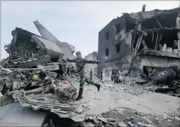  ?? — THE ASSOCIATED PRESS ?? Rescuers search for victims at the site where an Indonesian air force transport plane crashed in Medan, North Sumatra, Indonesia Wednesday. The plane crashed into a residentia­l neighbourh­ood Tuesday, killing 141 people.