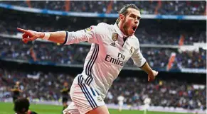  ??  ?? Reeling in delight: Real Madrid’s Gareth Bale celebrates after scoring against Espanyol in the La Liga on Saturday. — AP