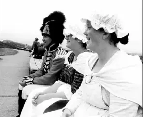  ?? — Photos by Colin Maclean/the Telegram ?? Signal Hill Tattoo re-enactors chat during a break from the War of 1812 performanc­e on Saturday. From left are Kendall Carmichael, Rachel Hedges and Samantha Gosse.