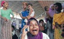  ?? Photo: REUTERS ?? A Rohingya migrant who arrived in Indonesia by boat cries while speaking on a mobile phone with a relative in Malaysia, at a temporary shelter in Kuala Langsa in Indonesia’s Aceh Province.