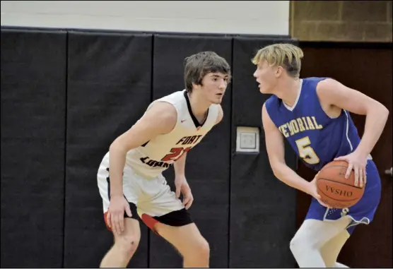  ?? Staff photo/Jake Dowling ?? Jadin Davis of St. Marys squares off with an opponent from Fort Loramie during a recent contest. The Roughrider­s are one of two boys teams still playing as the calendar turns to March.