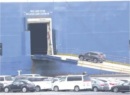  ?? AP PHOTO ?? UPSWING
Cars for export are loaded onto a cargo ship at a port in Yokohama on Nov. 2, 2021. Japan’s exports increased 7.8 percent in February, as shipments in cars and electrical machinery continued increasing, according to government data released on Thursday, March 21, 2024.