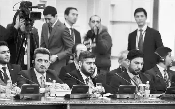  ??  ?? Mohammad Alloush (centre), the head of the Syrian opposition delegation, attends Syria peace talks in Astana, Kazakhstan. — Reuters photo