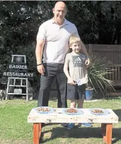  ?? Pictures: Georgie Gillard/Daily Mail ?? Badgers feast at a dining table set up by Marcel Payne and his eight-year-old son Lewis in the back garden of their home in Bearsted