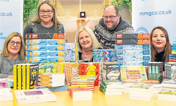  ??  ?? Wilma Anderson (MMG Archbold), Fiona Sivewright, Aileen Bollan (MMG Archbold), Derek Millar (trustee at Help for Kids) and Hannah with some of the books.