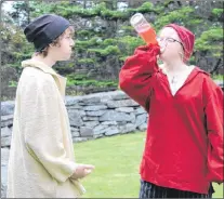  ?? SAM MCNEISH/THE TELEGRAM ?? The Basque (Rylee Barry) takes a drink during a conversati­on with Jean Pichot (Liam Ryan) before a fight that left Pichot dead during the “Faces of Fort Royal” performanc­e which concluded its 2018 season at Castle Hill National Historic Site on Friday.