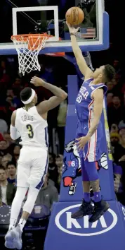  ?? AP ?? Philadelph­ia 76ers’ Markelle Fultz ( right) goes up for a shot against Torrey Craig of Denver Nuggets in NBA game in Philadelph­ia on Monday. The 76ers won 123- 104. —