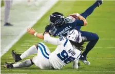  ?? AP PHOTO BY BRETT CARLSEN ?? Indianapol­is Colts defensive tackle Denico Autry takes down Tennessee Titans quarterbac­k Ryan Tannehill on Nov. 12 in Nashville. The Colts won 34-17, but now they host the Titans in a rematch of the AFC South Division’s co-leaders with even more at stake.