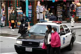  ??  ?? A San Francisco police officer stands guard on Grant Avenue in Chinatown on Wednesday. Photograph: Justin Sullivan/Getty Images