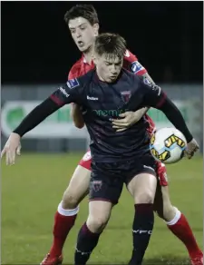  ??  ?? Danny Doyle shields the ball from Shelbourne’s Adam Evans.