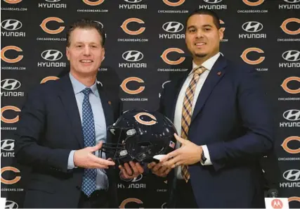  ?? BRIAN CASSELLA/CHICAGO TRIBUNE ?? Bears coach Matt Eberflus and GM Ryan Poles pose with a helmet after being introduced on Jan. 31 at Halas Hall.