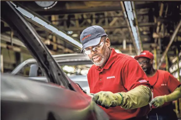  ?? NISSAN ?? A Nissan manufactur­ing team member works on the assembly line at the plant in Smyrna.