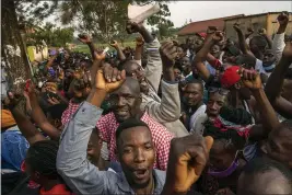  ?? JEROME DELAY — THE ASSOCIATED PRESS ?? Supporters of leading presidenti­al opposition challenger Bobi Wine cheer as election officials count the ballots after polls closed in Kampala, Uganda, Thursday.