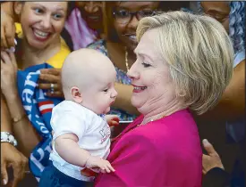  ?? AP ?? Democratic presidenti­al candidate Hillary Clinton greets a baby at a campaign rally in Pennsylvan­ia Tuesday.