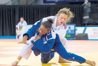  ??  ?? ‘Honorary Scot’ Kelly Edwards defeats Raquel Silva of Brazil to win gold