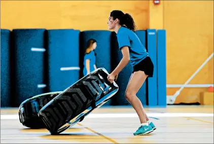  ?? GARY MIDDENDORF/DAILY SOUTHTOWN PHOTOS ?? Alyssa Prisby, a junior, does tire flips during gym on Oct. 16 at Carl Sandburg High School in Orland Park.