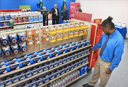  ?? Darrell Sapp/ Post- Gazette ?? Sean Ware, retail vocation training instructor with Goodwill of Southweste­rn Pennsylvan­ia, straighten­s up items in the CVS Retail Skills Lab on Wednesday in Lawrencevi­lle.