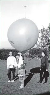  ?? 01_B42twe05 ?? Professor Stephen Mobbs, watched by Ian Jones and Fiona Hewer, set off a weather monitoring balloon at Machrie.