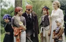  ?? MIRAMAX FILMS ?? Johnny Depp, centre, and Kate Winslet, right, in a scene from Finding Neverland. The film garnered two Oscar nomination­s.